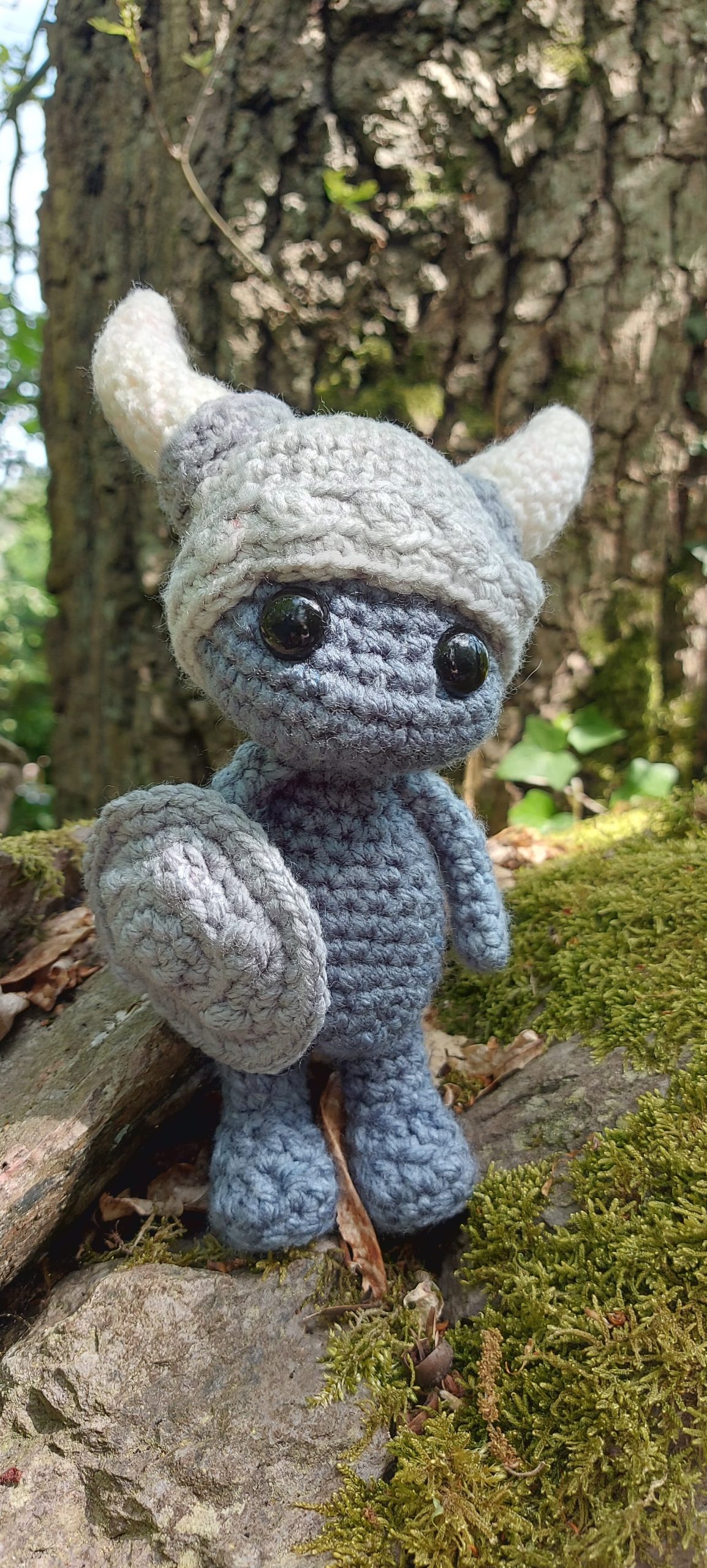 Crochet plushie in woodland setting