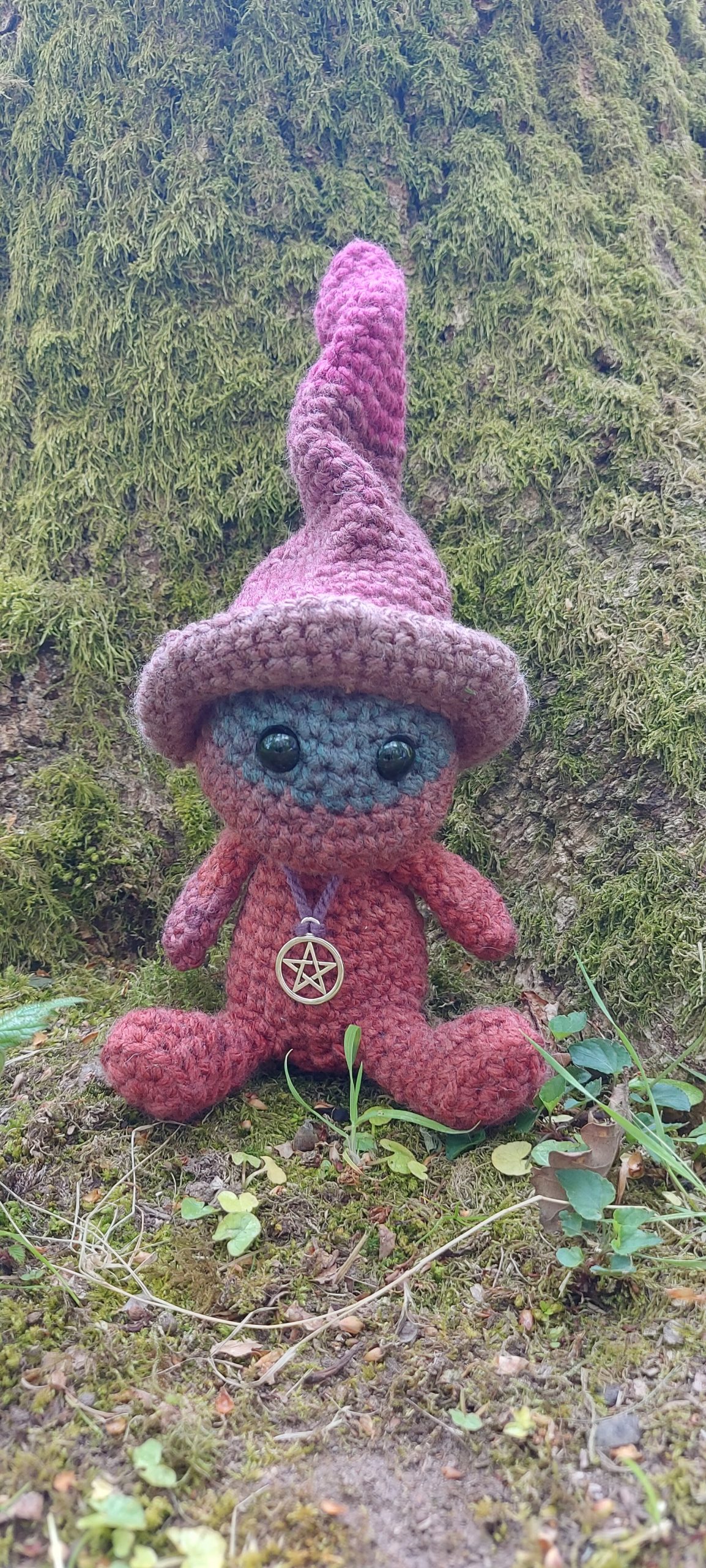 Crochet plushie sitting outdoors